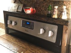 a silver and black stereo sitting on top of a wooden table