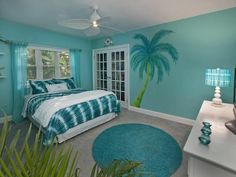 a bedroom decorated in blue and green with palm trees on the wall behind the bed