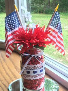 a mason jar filled with red, white and blue flowers