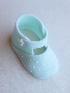 a pair of baby blue shoes sitting on top of a table