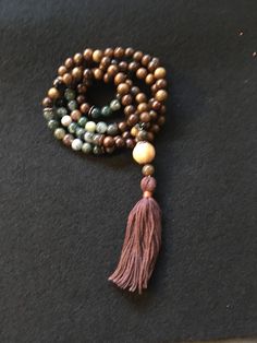 This beautiful full mala is made of 108 8mm Rosewood and Fancy Jasper beads, wood guru bead, with copper accents and handmade tassel. Fancy Jasper supports the spiritual traveler, guiding them into the flow of a loving,  nurturing, and grounding  energy, which is a wonderful balancer of emotions.  Wishing you love, peace, and infinite joy! * Mala beads, also known as prayer or meditation beads, are spiritual tools used for meditation and spiritual practice. Full, traditional malas consist of 108 Fancy Jasper, Grounding Energy, Meditation Beads, Spiritual Tools, Copper Accents, 108 Bead, Love Peace, Jasper Beads, Strand Bracelet