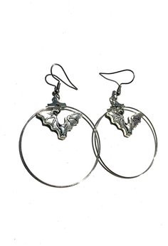 Shiny silver vampire bat earring hoops, perfectly spooky or something special for Halloween 🎃  Hoops measure approximately 40mm wide and the dainty bat charm hangs in the top centre. Made with stainless steel French hook style earrings Comes with a organza drawstring gift pouch to keep your earrings safe or give as a gift. Follow @helloween_13 on Instagram Edgy Pierced Halloween Earrings, Edgy Halloween Pierced Earrings, Edgy Pierced Earrings For Halloween, Nickel-free Punk Halloween Earrings, Nickel-free Punk Earrings For Halloween, Punk Nickel-free Earrings For Halloween, Punk Style Nickel Free Earrings For Halloween, Halloween Vampire Metal Earrings, Vampire Style Metal Earrings For Halloween