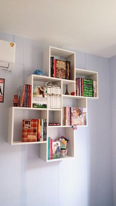 a bookshelf filled with lots of books next to a wall mounted air conditioner