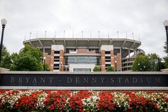 the entrance to bryant - denny stadium with flowers in front