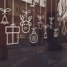 a window with christmas decorations drawn on it