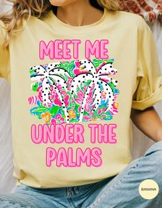 Escape to your tropical haven with our **Palms Paradise Rendezvous Tee**! This breezy, soft cotton shirt features the whimsical phrase "Meet Me Under the Palms," inviting you to daydream about sun-soaked beaches and swaying palm trees. Perfect for summer adventures, beach outings, or just adding a touch of paradise to your everyday style. Embrace the laid-back vibes and make every day a getaway with this must-have tee! Printed Yellow T-shirt For Vacation, Yellow Printed T-shirt For Vacation, Tropical Palm Tree Print T-shirt For Spring, Spring Tropical T-shirt With Palm Tree Print, Spring Summer Tropical Print T-shirt, Tropical Print T-shirt For Spring And Summer, Tropical Print T-shirt For Spring Summer, Spring Vacation T-shirt With Palm Tree Print, Spring Tropical Tops With Letter Print