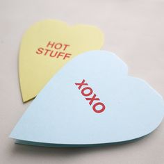 two heart shaped sticky notes with the words hot stuff and xoxo on them