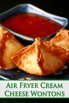 an air fryer cream cheese wontons on a plate with dipping sauce in the background