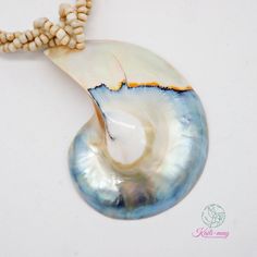 The White Nautilus shell is from the south of Thailand and partly from the Philippines and crafted in Indonesia. The Necklace is made of small white Racine beads and strung together with each bead to be a beading line and twisting each line to be one line for stronger and look beautiful, and it is 18 inches long, weight 45g. (including pendant) It's a real seashell from farming which it's fed by seaweed, not from the natural environment due to environmental conservation. Our product was crafted with craftsmanship from one generation to one generation, and it may not last forever. Unlike a product that is made by machine. It's not just an ordinary necklace but it's about the taste of the wearer. It's for you or anyone who infatuates nature and each of the shells may lookalike but not exactl White Beaded Shell, Handmade Spiritual Shell, Handmade Pearl Shell-shaped Shell, Pearl Beaded Shell, Handmade White Shells For Jewelry Making, Handmade Mother Of Pearl Shell, Beaded Pearl Shell-shaped Necklace, Handmade Pearl White Shell Necklace, Beaded Mother Of Pearl Shell-shaped Jewelry