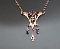 1900 - 1910's, Germany.  Pinchbeck, rose gold washed. Synthetic rubies. Good antique condition.  One dark spot. Stones intact. From end to end 15 3/8"    (39cm). Pendant:  1" x 1 1/4"   (25 x 31mm).  Weight: 3,8g. * * * All our items are packed in gift boxes, easy to check of content and re-pack. If you wish something special, please let us know. * * * LAYAWAYS: All items can be put on layaway, max 4 months. First payment should be no less than 1/4 of total price including non-refundable 10% dep Antique Rose Gold Necklace For Formal Occasions, Formal Victorian Rose Gold Necklace, Antique Rose Gold Necklace For Anniversary, Victorian Rose Gold Necklaces For Wedding, Victorian Rose Gold Hallmarked Jewelry, Victorian Rose Gold Necklace For Wedding, Vintage Rose Gold Filigree Necklaces, Victorian Rose Gold Wedding Necklaces, Art Nouveau Rose Gold Jewelry As A Gift