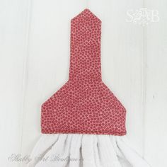 a red and white flowered tie hanging on a wall