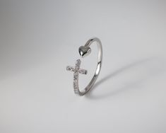 The Heart and cross ring are a symbol of unwavering faith and boundless love. Crafted with passion, this exquisite piece features a delicate heart and a cross, adorned in cubic zirconia stones, creating a harmonious fusion of spirituality and devotion. The ring is adjustable and will always be a perfect fit. Wear it and let its beauty inspire you to embrace the blessings of faith and compassion. Details: Adjustable ring Materials: Copper and silver plated / gold plated Available colors: Silver o Heart And Cross, Open Heart Ring, Unwavering Faith, Faith Jewelry, Silver Heart Ring, Cross Ring, Anklet Bracelet, Open Heart, Multi Stone Ring