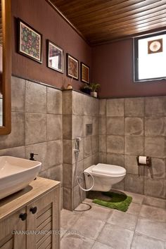 a bathroom with a toilet, sink and mirror