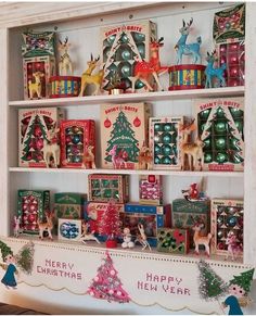 a shelf filled with lots of christmas decorations on top of a white wall next to a wooden bench