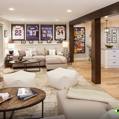 a living room filled with lots of furniture and pictures on the wall above it's fireplace