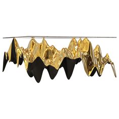 gold foiled paper hanging from a clothes line with mountains in the background on a white background