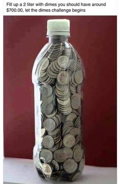 a bottle filled with coins sitting on top of a table