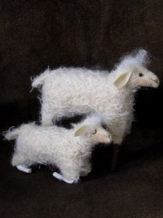 two white sheep standing next to each other