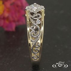 an intricately designed wedding ring with a diamond