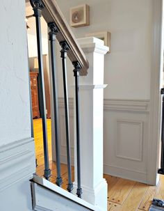 an image of a stair case in a house with wood flooring and white walls