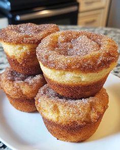 four sugared donuts stacked on top of each other