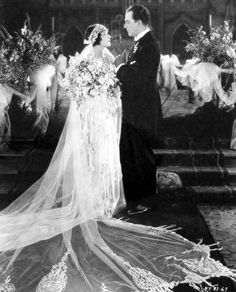 an old black and white photo of a bride and groom standing in front of the alter