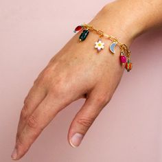 We love this bracelet! The multi-colored loveliness of the Lorelei Charm Bracelet is packed full of unique beauty and is sure to bring a fresh new feel into your jewelry collection. This paperclip chain bracelet includes an assortment of colorful charms. You can wear this bracelet solo on your wrist or stack it with other bracelets to create a look all your own. Single strand Approximately 8 inches long Gold plated over brass chain and clasp Lobster clasp Adjustable Nickel and lead free Beads in Trendy Multicolor Chain Bracelet For Gift, Trendy Multicolor Jewelry With Removable Charms, Trendy Multicolor Charm Bracelet, Playful Multicolor Jewelry With Removable Charms, Dainty Multicolor Bracelets With Adjustable Chain, Trendy Multicolor Bracelet With Flower Charm, Multicolor Trendy Bracelet With Flower Charm, Trendy Multicolor Bracelets With Flower Charm, Trendy Paperclip Bracelet For Gift