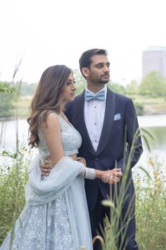 a man in a tuxedo and a woman in a dress standing next to each other