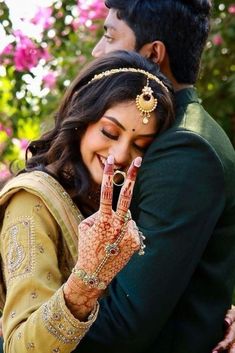 a bride and groom holding their hands together