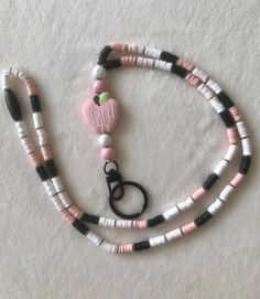 Perfect for a gift to any educator or as a gift to yourself!  - Silicone Heishi style beads - Silicone rainbow "TEACH" at base with wooden beads - Black, white, beige, and pink beads - Easy on and off - Made with nylon cord - Approximately 21.5 inches in length - Break-away clasp at neck - Black swivel clasp with ring included Smoke-free home Cute White Craft Supplies For Personal Use, Cute White Crafts For Gifts, Pink Beaded Craft Supplies For Gifts, White Beaded Craft Supplies For Gifts, Cute Customizable White Craft Supplies, Pink Letter Beads Craft Supplies, Pink Customizable Craft Supplies, Pink Handmade Crafts For Gift Making, Customizable Pink Craft Supplies