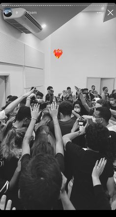 a group of people standing around each other with their hands up in front of them