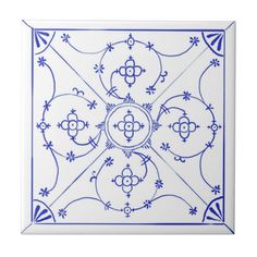 a blue and white tile with an intricate design on the bottom, in square shape