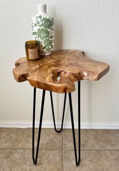 a wooden table with black hairpin legs and a jar on the top, next to it