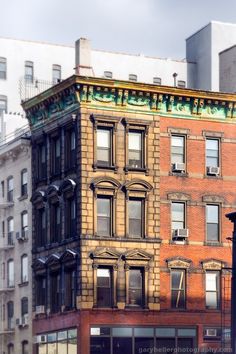 an old brick building in the city with lots of windows on it's side