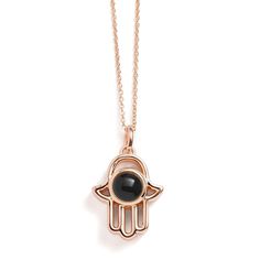 Introducing our Personalized Hamsa Necklace, a unique accessory that blends tradition with personal storytelling. This necklace features a Hamsa pendant, a symbol of protection and good fortune, designed to hold a special photo inside. It's not just a piece of jewelry; it's a personal talisman that keeps your cherished memories close to your heart. Perfect for everyday wear or as a meaningful gift, this necklace adds a personal touch and a layer of significance to your style, ensuring that what' Amulet Style Pendant Necklace With Charms, Black Amulet Locket Jewelry, Good Luck Medallion Necklace With Charms, Personalized Spiritual Necklaces For Keepsake, Good Luck Charms Pendant Necklace, Spiritual Medallion Pendant Necklace With Charms, Symbolic Rose Gold Jewelry Gift, Amulet Style Charm Necklaces With Locket Pendant, Gift Amulet Charm Necklaces With Locket