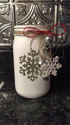 a white jar filled with ornaments on top of a counter