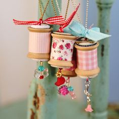 three small jars with bows hanging from them