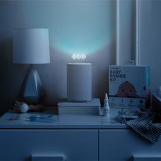 a night light on top of a dresser next to a book and other items in front of it