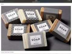 five soap bars sitting next to each other on top of a gray surface with black and white designs