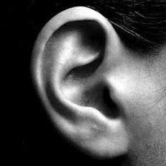 a woman's ear is shown in black and white