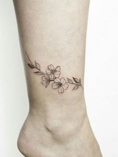 a small flower tattoo on the ankle