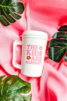 the kids are alright coffee mug on pink satin with monster leaves