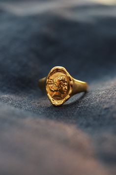 Apollo Gold Chunky Signet Ring is inspired by the god of sun Apollo in Greek mythology, a figure of Apollo's portrait engraved on a molten golden wax seal style signet ring. We are the original creator of this Apollo Signet Ring! Vintage-inspired, both classic and modern, this ring is the perfect everyday signet ring. ◊ 18K gold plating over recycled brass ◊ Available in US ring size 6 to 7 ◊ Delivered in our signature royal blue box, it makes the perfect gift! SAY HI TO US Instagram: @thepinabl Signet Ring Vintage, Crystal Point Jewelry, Christian Ring, Elizabeth Queen, Gold Coin Ring, Queen Rings, Vintage Rose Gold, Gold Statement Ring, Coin Ring