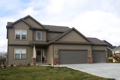 a large house with two garages in the front and one on the other side