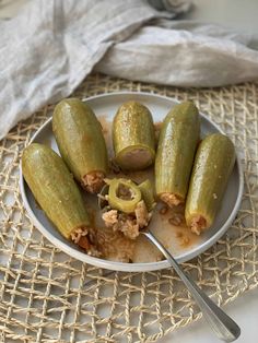 a white plate topped with pickles covered in sauce