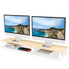 two computer monitors sitting next to each other