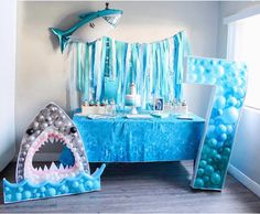 a shark themed birthday party with balloons and decorations