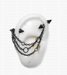 a white mask with black spikes and chains on it's face is shown in front of a white background