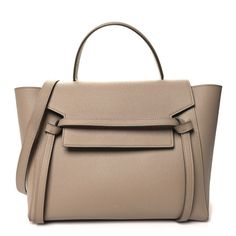 This is an authentic CELINE Grained Calfskin Mini Belt Bag in Light Taupe. This chic handbag is crafted of grained calfskin leather with a structured silhouette. The bag features a leather top handle, a removable shoulder strap, a back zipper pocket, and a front flap that is secured with decorative knotted straps. The flap opens to a suede interior with hanging leather patch pockets. Celine Box, Mini Belt Bag, Celine Belt Bag, Bag Light, Chic Handbags, Leather Patches, Flap Bag, Leather Top, Bag Straps