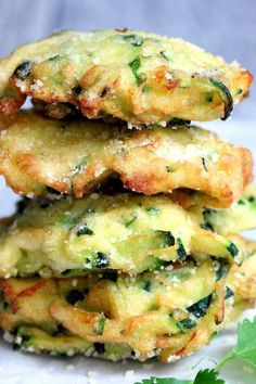 three fritters stacked on top of each other with parsley in the background